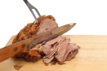 Braten, geschnitten mit Tranchiermesser und Fleischgabel